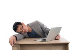 Businessman sleeping next to his laptop computer with white back stock photography Businessman sleeping next to his laptop computer with white back stock photography
