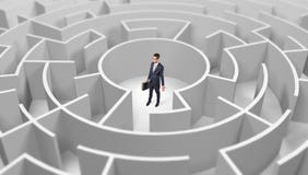 Businessman standing in a middle of a round maze stock image Businessman standing in a middle of a round maze stock image