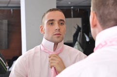 Businessman ties his neck-tie stock photo Businessman ties his neck-tie stock photo