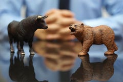 Businessman is watching bull and bear , concept of stock market stock photo Businessman is watching bull and bear , concept of stock market stock photo