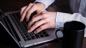 Businessman working on laptop in office stock photo Businessman working on laptop in office stock photo