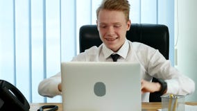 Businessman working at the laptop, rejoices and laughs, learning good news stock footage Businessman working at the laptop, rejoices and laughs, learning good news stock footage