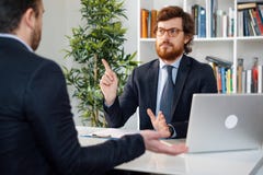 Businessmen arguing at workplace after deal failure and breaking contract royalty free stock photography Businessmen arguing at workplace after deal failure and breaking contract royalty free stock photography