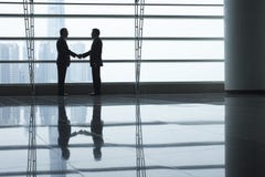 Businessmen Shaking Hands In Airport Terminal Royalty Free Stock Photos Businessmen Shaking Hands In Airport Terminal Royalty Free Stock Photos