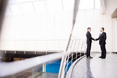 Businessmen shaking hands in office Stock Photos Businessmen shaking hands in office Stock Photos