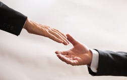 Businessmen in suits reach out to each other for handshake, help, deal, Finance Royalty Free Stock Photos Businessmen in suits reach out to each other for handshake, help, deal, Finance Royalty Free Stock Photos