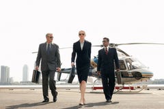 Businesspeople Arriving From Helicopter Stock Image