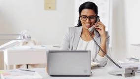Businesswoman calling on phone at office