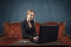 Businesswoman, happy woman in suit smiling using laptop for work in vintage interior Stock Images Businesswoman, happy woman in suit smiling using laptop for work in vintage interior Stock Images