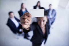 Businesswoman holding a business card up to the camera- Shannon Fagan Photography Stock Images Businesswoman holding a business card up to the camera- Shannon Fagan Photography Stock Images