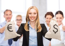 Businesswoman holding money bags with dollars Royalty Free Stock Images Businesswoman holding money bags with dollars Royalty Free Stock Images