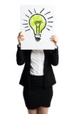 Businesswoman holding a white card with a drawn lightbulb in front of her. Isolated on white Royalty Free Stock Photography Businesswoman holding a white card with a drawn lightbulb in front of her. Isolated on white Royalty Free Stock Photography