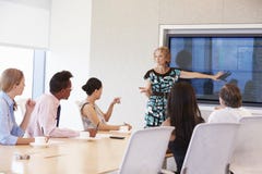 Businesswoman By Screen Addressing Boardroom Meeting stock photos Businesswoman By Screen Addressing Boardroom Meeting stock photos