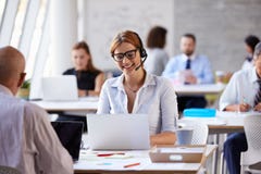 Businesswoman Using Laptop In Customer Service Department royalty free stock image Businesswoman Using Laptop In Customer Service Department royalty free stock image