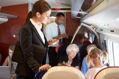 Businesswoman Using Mobile Phone On Busy Commuter Train stock images Businesswoman Using Mobile Phone On Busy Commuter Train stock images
