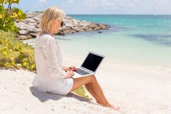 Businesswoman Working With Computer On The Beach Stock Images