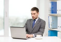 Busy businessman with laptop and coffee stock photos Busy businessman with laptop and coffee stock photos