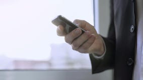 Busy man scrolling touchscreen on smartphone, checking business news online stock image Busy man scrolling touchscreen on smartphone, checking business news online stock image
