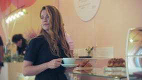 She buyer chooses yummy. Young attractive girl, woman buys in the coffee shop or pastries, cakes, cake, macaroon. A stock footage She buyer chooses yummy. Young attractive girl, woman buys in the coffee shop or pastries, cakes, cake, macaroon. A stock footage