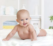 Bébé de sourire dans la couche-culotte ou la couche images stock Bébé de sourire dans la couche-culotte ou la couche images stock