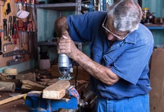 Cabinet maker working with wood saw in the workbench in garage a royalty free stock photos Cabinet maker working with wood saw in the workbench in garage a royalty free stock photos