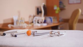 The cabinet of neurologist, medical tools in the foreground, models of skeletons on the table Stock Images The cabinet of neurologist, medical tools in the foreground, models of skeletons on the table Stock Images