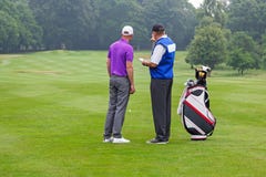 Caddy pointing out a hazard to golfer stock photos Caddy pointing out a hazard to golfer stock photos