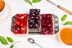 Cakes with strawberries, cherries,raspberries and cups of tea stock image Cakes with strawberries, cherries,raspberries and cups of tea stock image