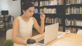 Calculating the cost of postage of a small package, Small business enterprise concerns stock photo Calculating the cost of postage of a small package, Small business enterprise concerns stock photo
