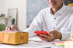 Calculating the cost of postage of a small package royalty free stock photography Calculating the cost of postage of a small package royalty free stock photography