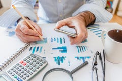 Calculator, pen and glasses with financial graphs royalty free stock photography Calculator, pen and glasses with financial graphs royalty free stock photography