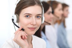 Call center. Beautiful cheerful smiling operator consulting clients with headset. Business concept of customer service stock photo Call center. Beautiful cheerful smiling operator consulting clients with headset. Business concept of customer service stock photo