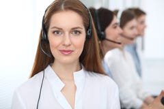 Call center. Beautiful cheerful smiling operator consulting clients with headset. Business concept of customer service stock image Call center. Beautiful cheerful smiling operator consulting clients with headset. Business concept of customer service stock image
