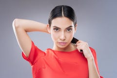 Calm pleasant woman looking at her own reflection stock photos Calm pleasant woman looking at her own reflection stock photos