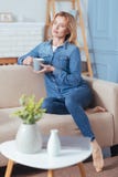 Calm Young Woman Sitting On A Sofa And Holding A Mug Royalty Free Stock Photos