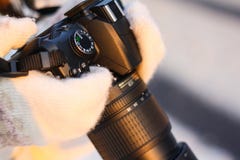 Camera in the hands of a girl in the winter forest stock photo Camera in the hands of a girl in the winter forest stock photo