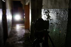 Camera on tripod in dark abandoned building. Urban exploration concept royalty free stock image Camera on tripod in dark abandoned building. Urban exploration concept royalty free stock image