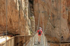 Crossing cliffes by a hanging bridge with calbes stock photo Crossing cliffes by a hanging bridge with calbes stock photo
