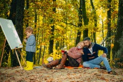 Camping with kids. Little artist painting picture. Autumn garden party Father, mather and son. We like autumn time stock image Camping with kids. Little artist painting picture. Autumn garden party Father, mather and son. We like autumn time stock image