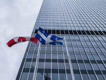 Canadian and Quebec flags in front of a skyscraper stock images Canadian and Quebec flags in front of a skyscraper stock images