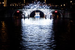 A boat passes through a light filled tunnel in Amsterdam, Nether royalty free stock photography A boat passes through a light filled tunnel in Amsterdam, Nether royalty free stock photography