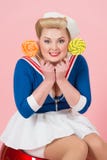 Candy woman in retro pin-up style. Blonde girl with candies in hands. Beautiful happy woman with lollipops isolated in studio. stock images Candy woman in retro pin-up style. Blonde girl with candies in hands. Beautiful happy woman with lollipops isolated in studio. stock images