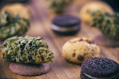 Cannabis nugs over infused chocolate chips cookies - medical mar stock image Cannabis nugs over infused chocolate chips cookies - medical mar stock image
