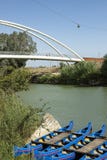 Canoes Anchored At Harbour In Green River With The Bridge In The Background. Maremma, Tuscany, Italy Royalty Free Stock Image Canoes Anchored At Harbour In Green River With The Bridge In The Background. Maremma, Tuscany, Italy Royalty Free Stock Image