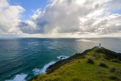 Beautiful Pacific Ocean landscape with lighthouse on the top of cliff peak, Cape Reinga light house, Northland, New Zealand royalty free stock image Beautiful Pacific Ocean landscape with lighthouse on the top of cliff peak, Cape Reinga light house, Northland, New Zealand royalty free stock image