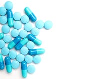 Capsule e pillole blu rovesciate della medicina Immagini Stock Capsule e pillole blu rovesciate della medicina Immagini Stock