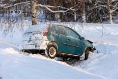 Car accident in winter conditions. Vehicle wreck in a ditch in snow.