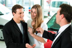 Car sales - key being given to couple