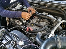 Car service engine, repair, check up maintenance, auto mechanic man tightened valve under hood car, people hand fixing car engine stock photography Car service engine, repair, check up maintenance, auto mechanic man tightened valve under hood car, people hand fixing car engine stock photography
