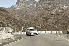 Car traveling downhill on curved mountain roads. Vehicle driving driving in a hairpin bend shoot from car. Rural Roadside. Road stock photography Car traveling downhill on curved mountain roads. Vehicle driving driving in a hairpin bend shoot from car. Rural Roadside. Road stock photography